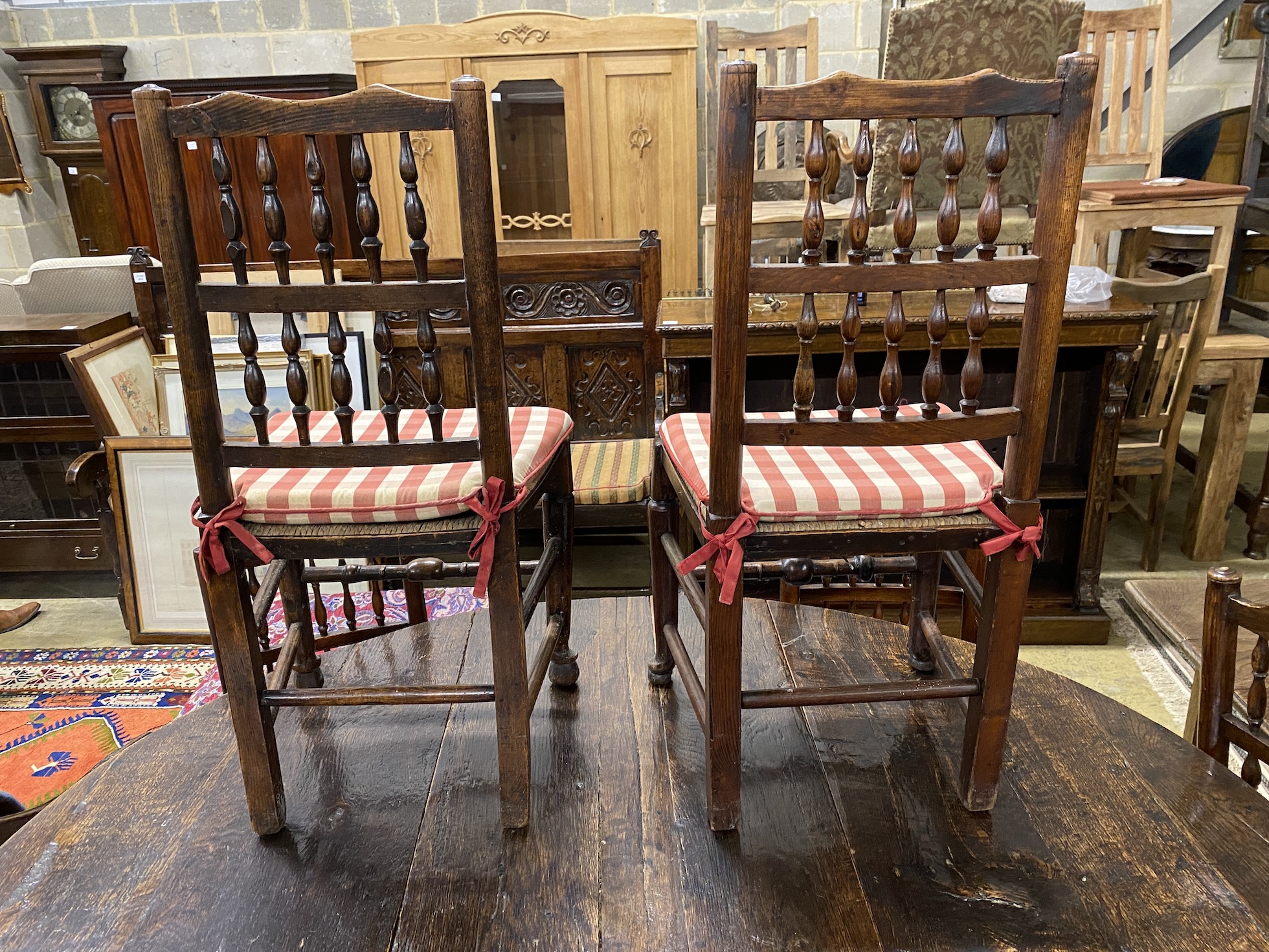 A set of eight Lancashire rush seat spindle back dining chairs, and one other